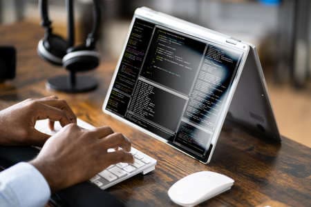 African American Coder Using Computer At Desk. Web Developer